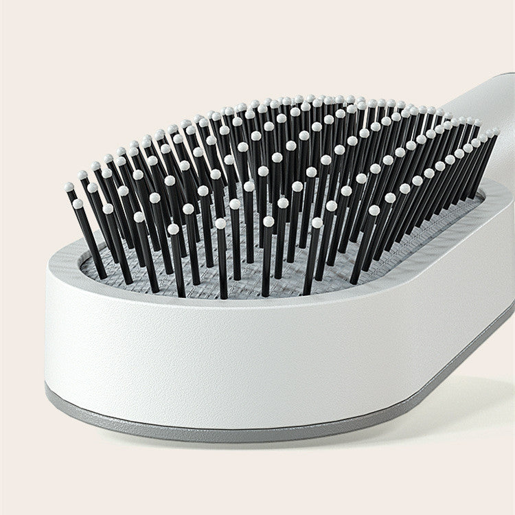 Self-cleaning hairbrush